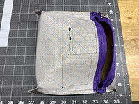 Corners popped out and diagonal lines sewn across popped out corners to create an angled bottom of the bag. Top perpendicular stitch lines done too to give it a small flat top.
