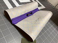 Zipper sliders added to join the two zipper halves and make a tube