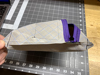Corners popped out and diagonal lines sewn across popped out corners to create an angled bottom of the bag. Top perpendicular stitch lines done too to give it a small flat top.