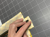 3/4" flap for binding, folded over at 3/8"-in, then folded one more time to create a double rolled hem. At this point everything can be sewn together, taking care to make sure the webbing loop inside is centered and aligned straight.