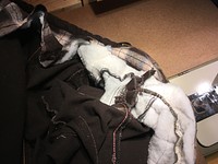 Thick insulation that will be carefully trimmed down, making sure not to cut any of the quilted seams.